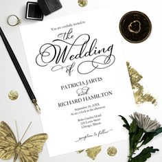 a wedding card with gold glitters on it next to a pair of scissors and some flowers