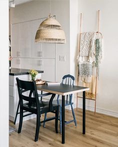 a kitchen table with two chairs next to it