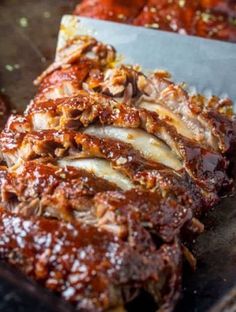 ribs covered in bbq sauce and garnished with parmesan cheese