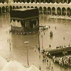 an old photo of people standing in flood waters surrounding the ka'bah mosque