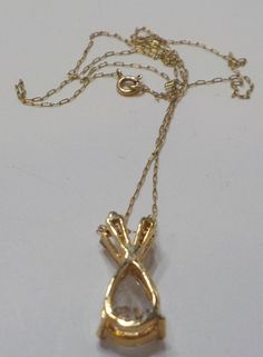 "Gorgeous vintage cubic zirconia (cz) pendant necklace. 16\" 14K gold chain with spring fastener. Gold tone teardrop pendant is 1/4\" x 5/8\" with a very sparkly faceted, CZ teardrop and two clear rhinestone baguettes. This is in mint condition and would be a gorgeous gift! Unsigned." Funky Necklace, Cz Pendant, Teardrop Pendant, Glass Bead Necklace, Gorgeous Gift, Clear Rhinestones, Pendant Necklaces, Gold Chain, Gold Chains