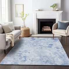 a living room filled with furniture and a blue rug on top of a hard wood floor