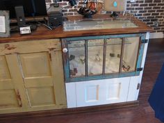 an old cabinet with glass doors is on display