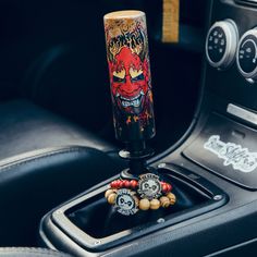 a car dashboard with a steering wheel knob and some decorations on it's center console