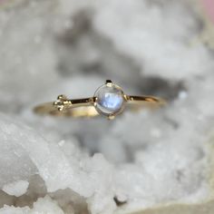 Every hero needs a sidekick...With our "Sidekick" ring in 14K gold, you can feel super all the time! Center moonstone is accented on one side by a tiny diamond. Super cute! - 4mm smooth moonstone - 1.3mm diamond - 1.3mm round band - Available in solid 10K or 14K gold For our amethyst "Sidekick" ring click here: https://www.etsy.com/listing/580095152/14k-amethyst-diamond-ring-sidekick-ring?ref=shop_home_active_23 Processing times -  Current processing time is 1 - 3 weeks. Each Item is handmade to Asymmetrical Ring, Pretty Engagement Rings, Ring Inspo, Ring Moonstone, Amethyst And Diamond Ring, Zierlicher Ring, Cabochon Ring, Tiny Diamond, Ring Sizer