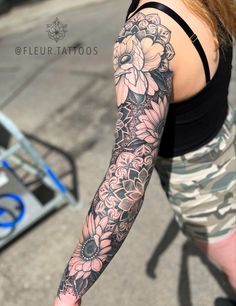 a woman with a flower tattoo on her arm