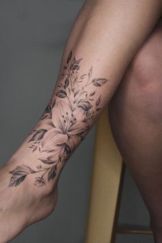 a woman's leg with flowers on it