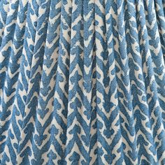 the pleaed fabric is blue and white with an abstract pattern on it's side