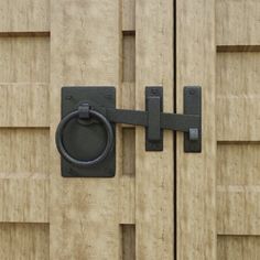 a close up of a wooden door with a metal handle on the front and side