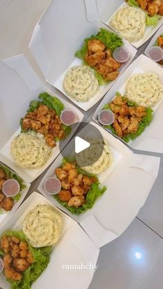 a table topped with lots of different types of food on top of white trays