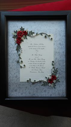 a framed poem with red roses on it