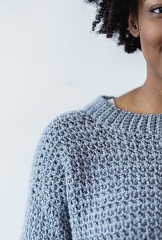 a close up of a person wearing a sweater