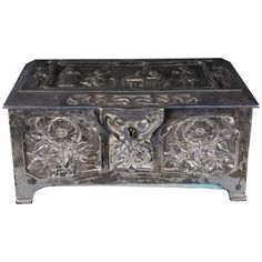 an ornate metal box with carvings on it