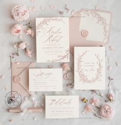 the wedding stationery is laid out with pink flowers and greenery, along with other items