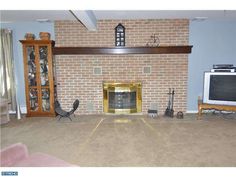 a living room with a fire place and television