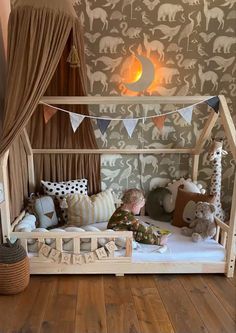 a child's bed with stuffed animals on it