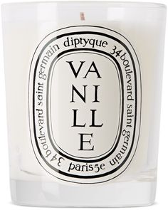 a white candle with black writing on it and an oval label that says vanilla in french