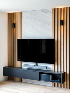 a flat screen tv mounted to the side of a wall