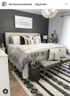 a bedroom with a bed, rugs and chandelier hanging from the ceiling