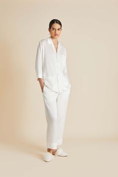 The Fifi Ivory Pearl pyjama is what sweet dreams are made of. Ensure a blissful sleep the night before your wedding (and every night thereafter) with this signature set, cut from the finest ivory silk satin and finished with real pearl buttons. Pair with the Audrey Ivory Pearl eye mask for a match made in heaven. Material: 100% silk Material Weight: 19 momme Material Weave: satin Colour: ivory Trims: flat silk piping, real pearl buttons Product Code: BR002 White Silk Pajamas, White Pyjamas, White Bridal Robe, Cashmere Robe, Bubu Gown Styles, Luxury Sleepwear, Olivia Von Halle, Family Pajama Sets, China Clothes