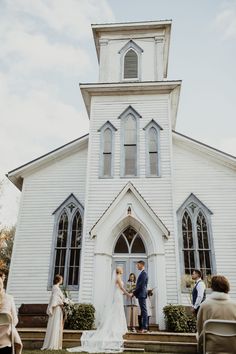 a couple getting married in front of a church