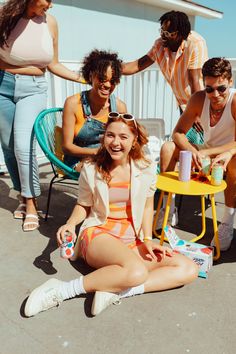 a group of people sitting around each other on the ground