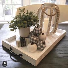 a tray with some pumpkins and other decorations on it