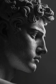 a black and white photo of a man's face with curly hair on his head