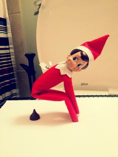 an elf is sitting on top of a table with his legs spread out to the side