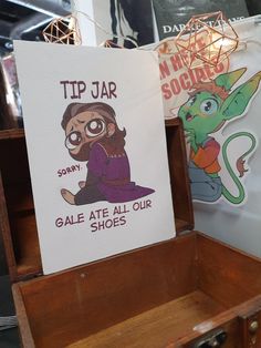 an open wooden box with a sign on it that says tip jar and gaie ate all our shoes