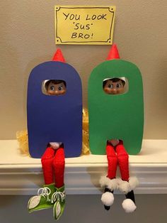 two elfs sitting on top of a shelf in front of a sign that says you look so bro