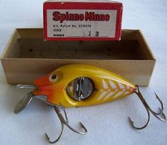 a yellow and orange fishing lure sitting in a box