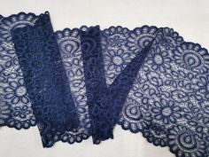 three pieces of blue lace sitting on top of each other