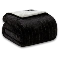 the black and white blanket is folded on top of each other, with a fuzzy edge