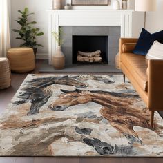 a living room with a couch, chair and rug in front of a fire place