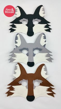 three masks with different colors and designs on them, one has an animal's face