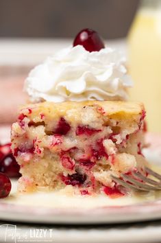 a piece of cake on a plate with whipped cream and cherries