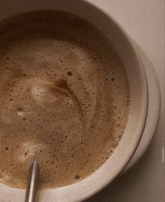 a cup of coffee with a spoon in it