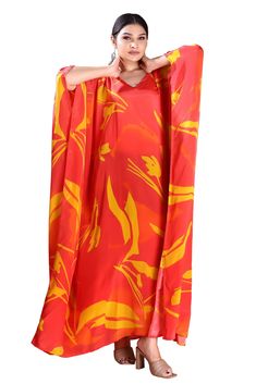 Make a statement in this bold and beautiful V-neck red silk caftan. Crafted from premium silk, this luxurious caftan features a flattering V-neckline that accentuates the décolletage and adds a touch of sophistication. The flowing silhouette drapes elegantly on the body, providing both comfort and style. Whether worn to a formal event or a casual gathering, this red silk caftan is sure to turn heads and make a lasting impression. Step out in confidence and showcase your unique sense of style wit Chic Silk V-neck Kaftan, Elegant V-neck Kaftan For Vacation, Silk V-neck Kaftan For Beachwear, Floor-length Flowy Kaftan, Red V-neck Beachwear Dress, Vibrant V-neck Kaftan For Vacation, Red Silk Maxi Kaftan, Elegant Red Kaftan For Evening, Red Silk Maxi-length Kaftan