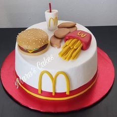 a birthday cake that is shaped like a mcdonald's burger, hot dog and fries