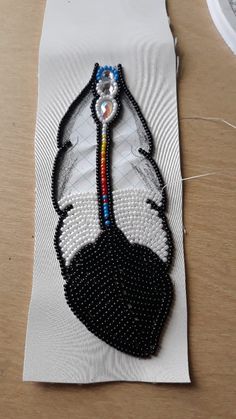 a piece of beaded art on top of a table