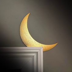 the moon is lit up on the wall