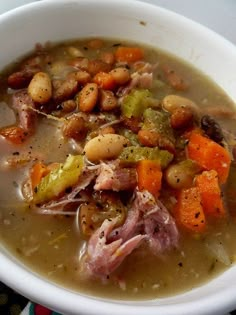 a white bowl filled with soup and vegetables