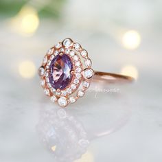 Beautiful Vintage Inspired Alexandrite Ring ►Can be paired with one or two half-eternity Milgrain bands of your choice (select option from a drop menu) ►Base Metal: Sterling Silver (S925) ►Plating: 14K Rose Gold Vermeil ►Accented With Simulated Diamonds Center Stone: Alexandrite Stone Cut: Oval Gem size: 7.0 x 5.0 mm Carat Weight: 0.76 (approx.) Gemstone creation: 100% Genuine Lab-Grown Alexandrite Stone Origin: Russia Hardness: 8.5 (Mohs scale) ►Handling time: 1-2 business days ►Free domestic s Classic 14k Rose Gold Rings With Accent Stones, Rose Gold Sapphire Ring With Center Stone For Anniversary, Rose Gold Sapphire Ring With Halo, 14k Rose Gold Rings With Bezel Setting For Anniversary, 14k Rose Gold Halo Promise Ring, Wedding Rings In 14k Rose Gold With Bezel Setting, Rose Gold Cluster Ring With Round Band For Anniversary, Heirloom 14k Rose Gold Promise Ring, 14k Rose Gold Halo Setting Promise Ring