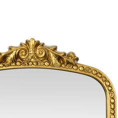 an ornate gold framed mirror against a white background