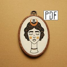 a hand embroidered picture of a woman's face on a piece of wood with the words pdf above it