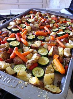 a pan filled with vegetables sitting on top of a stove