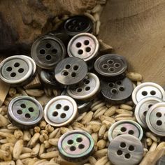 many buttons are placed in a pile of nuts and beans to be used for sewing