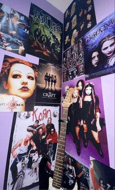 a guitar sitting on top of a purple wall covered in pictures and posters with the words korn written on it