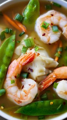 a white bowl filled with shrimp and veggies